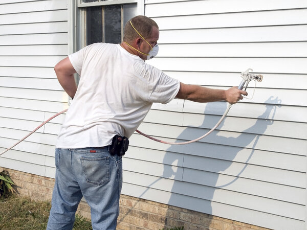 Repainting old vinyl siding with a paint sprayer